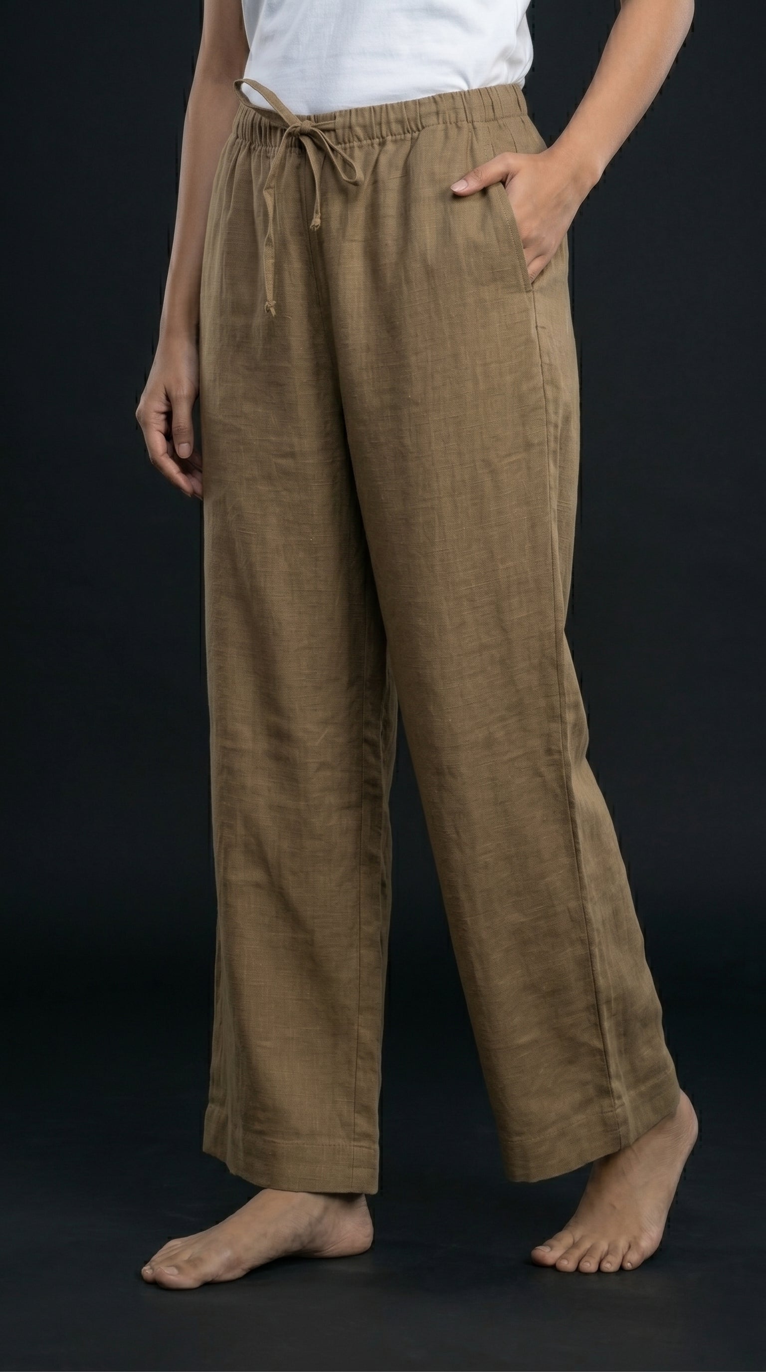 Person wearing khaki wide-leg pants on a black background